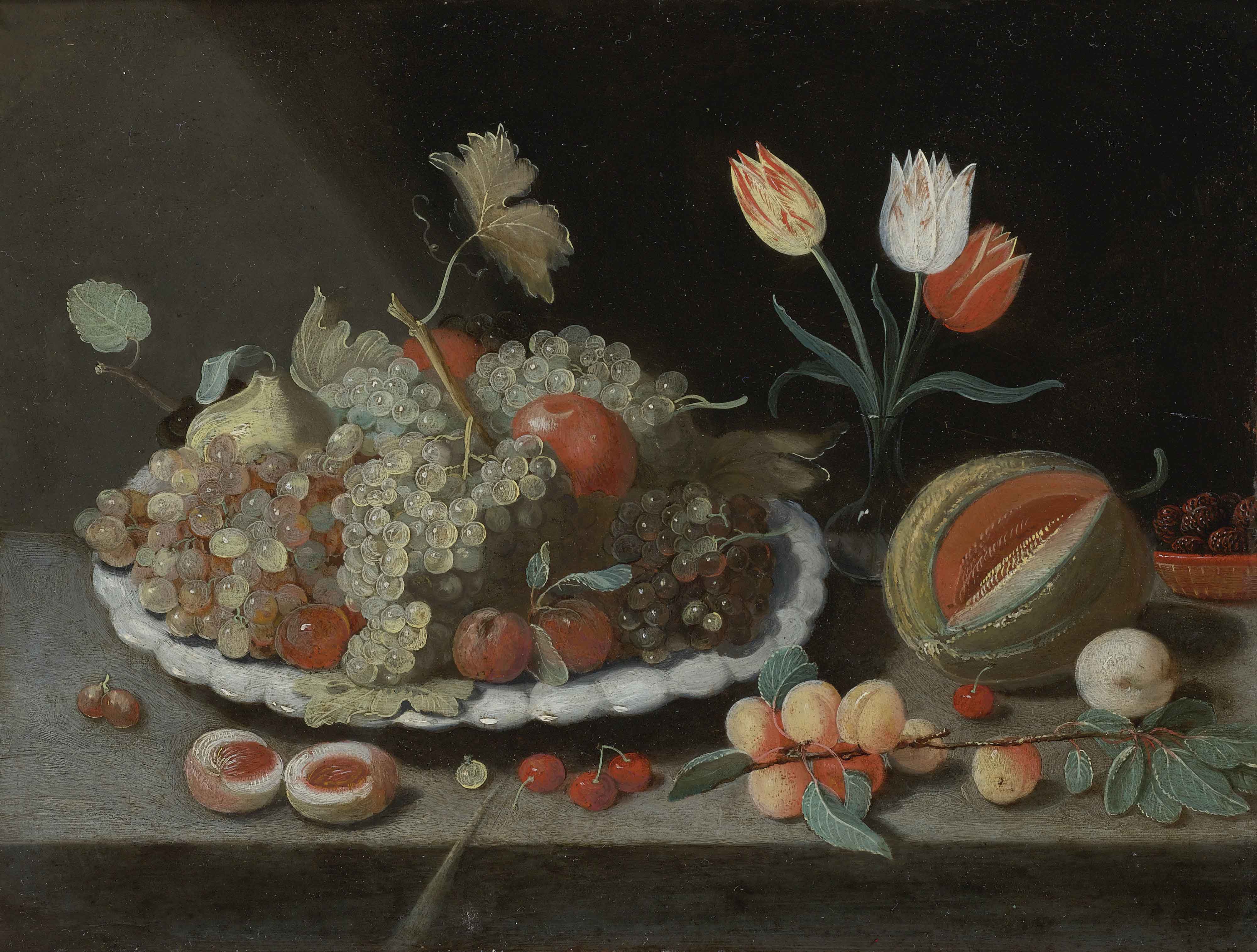Still life with grapes and other fruit on a platter